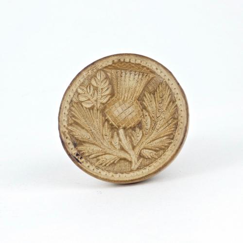 Small butter print carved with a thistle