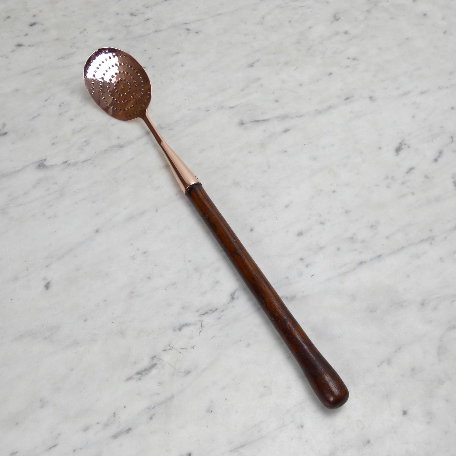 Copper straining spoon.
