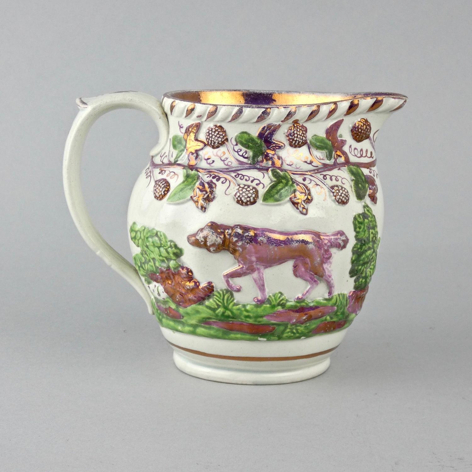 Staffordshire pink lustre jug moulded with dogs
