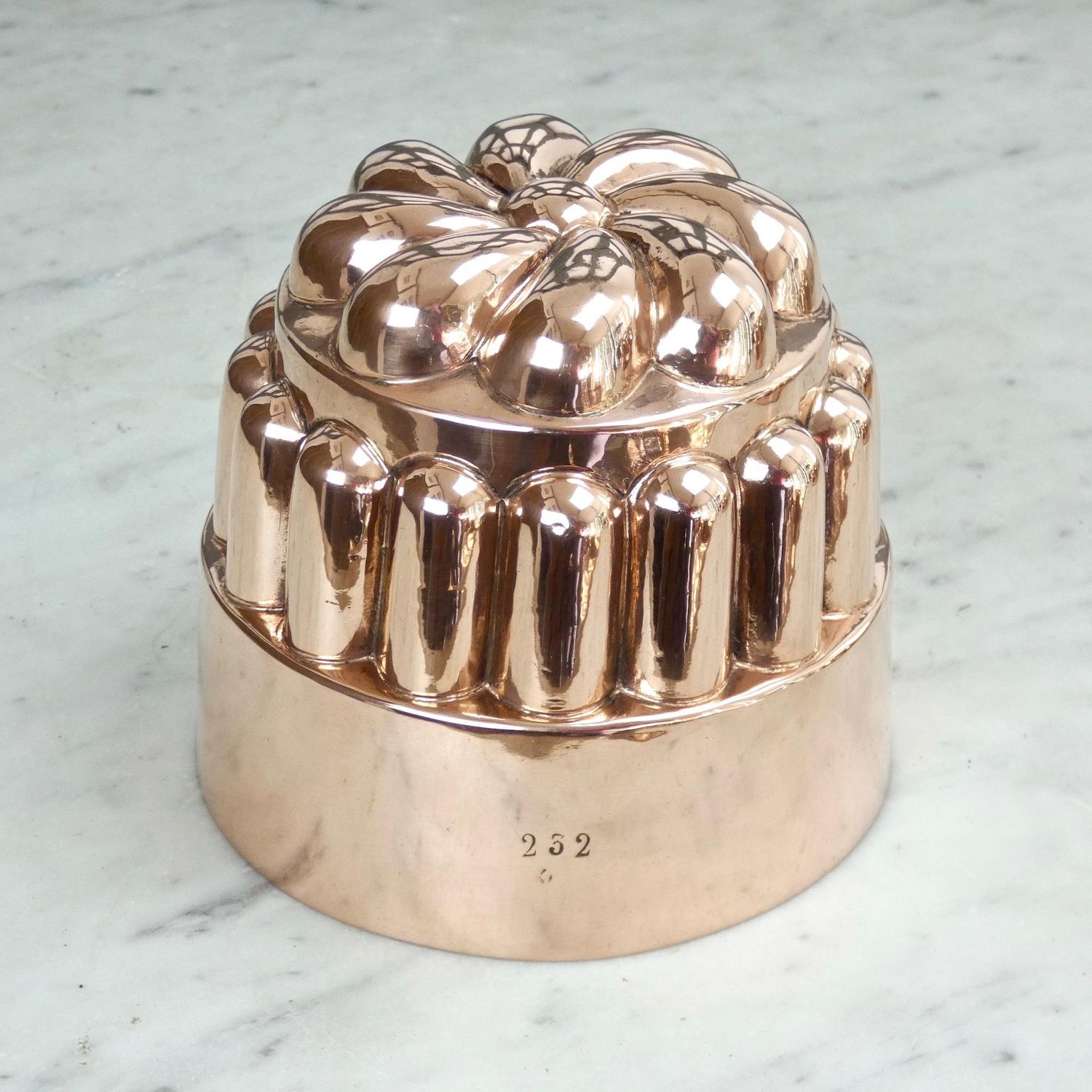 Copper mould with stylised flower top