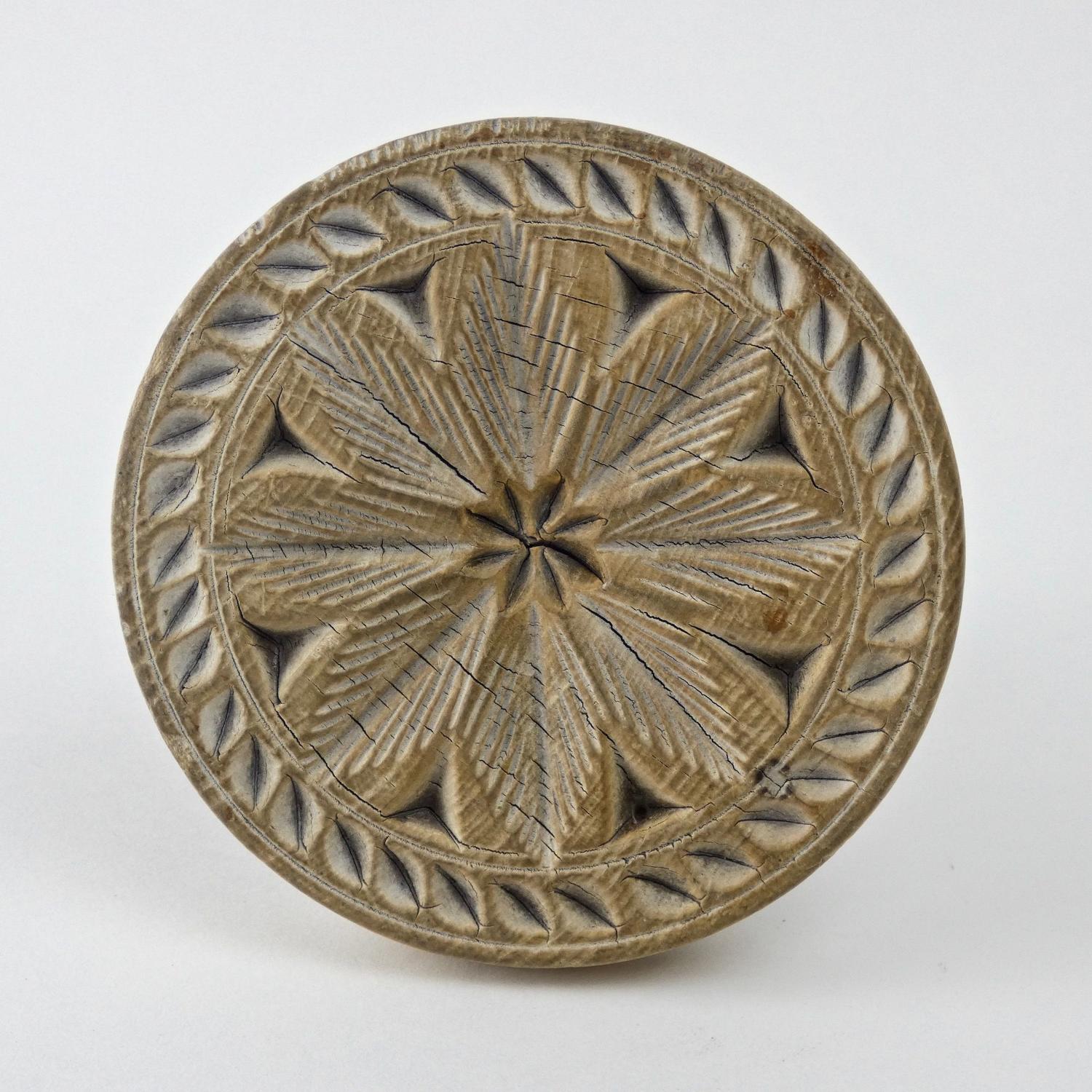 Sycamore butter print carved with a flower