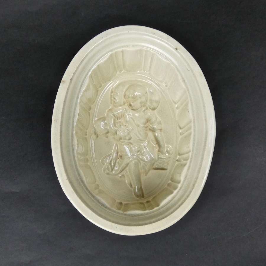 Rare, ceramic mould with child and dog.