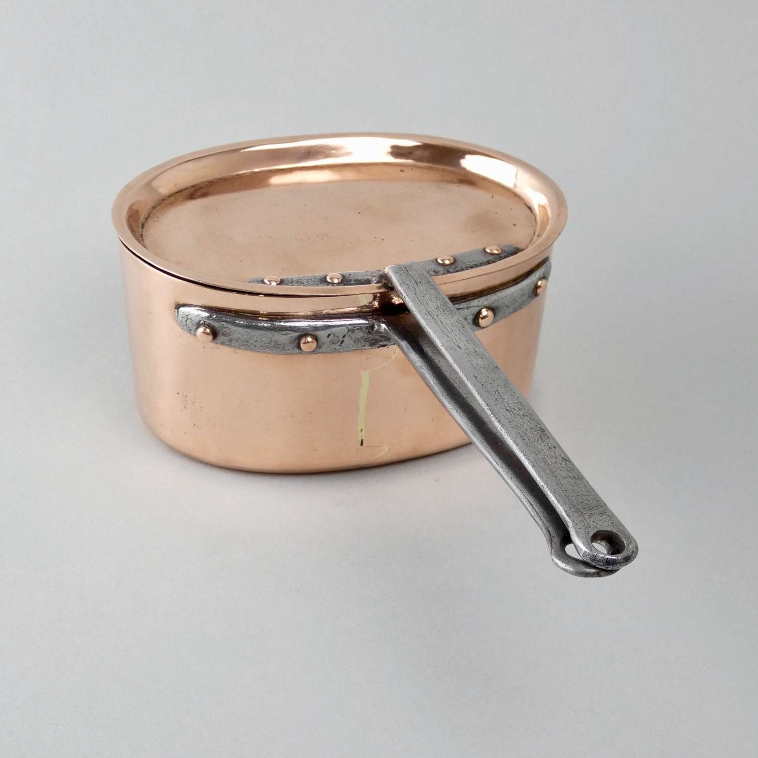 Small, oval copper saucepan