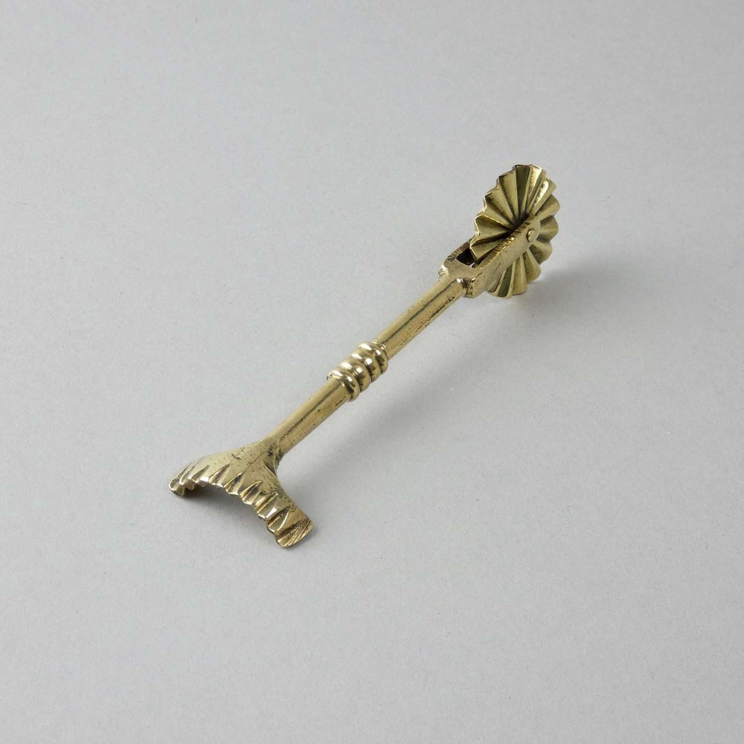 Small, brass pastry tool