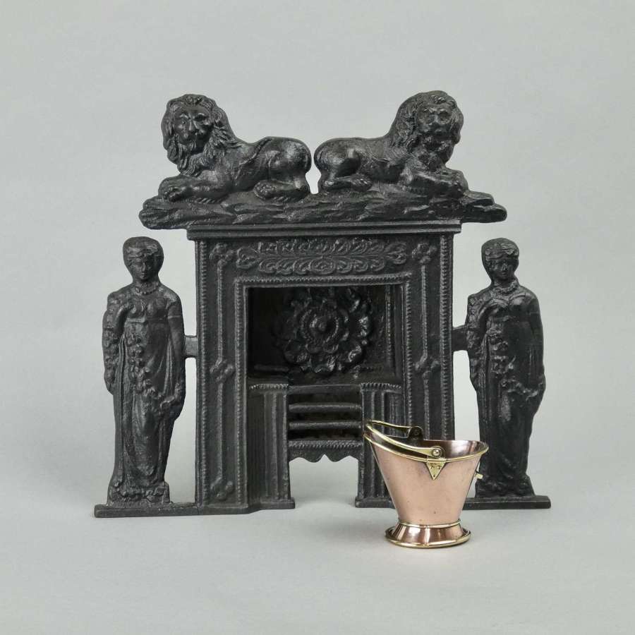 Miniature, cast iron fire grate with lions
