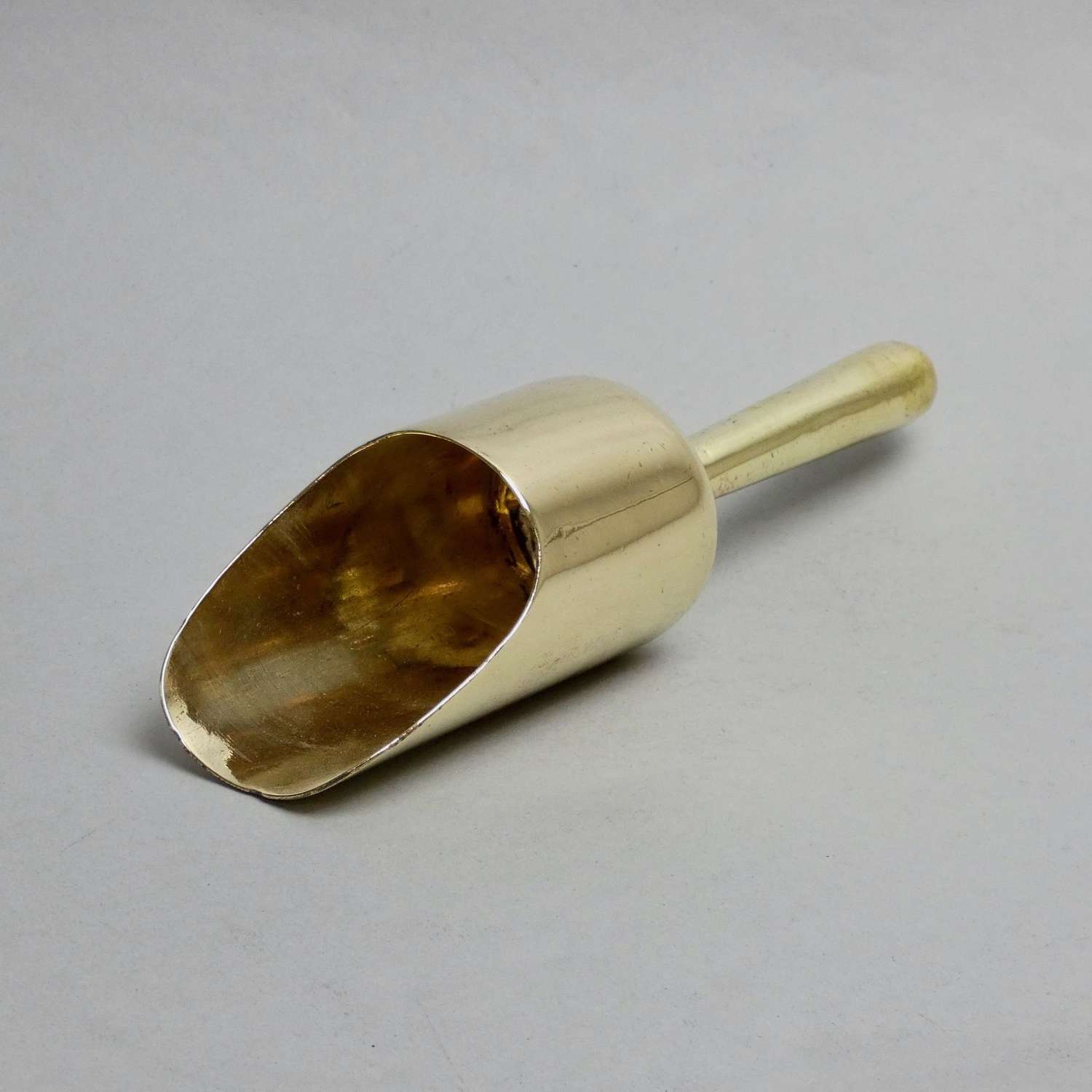 Small, brass scoop